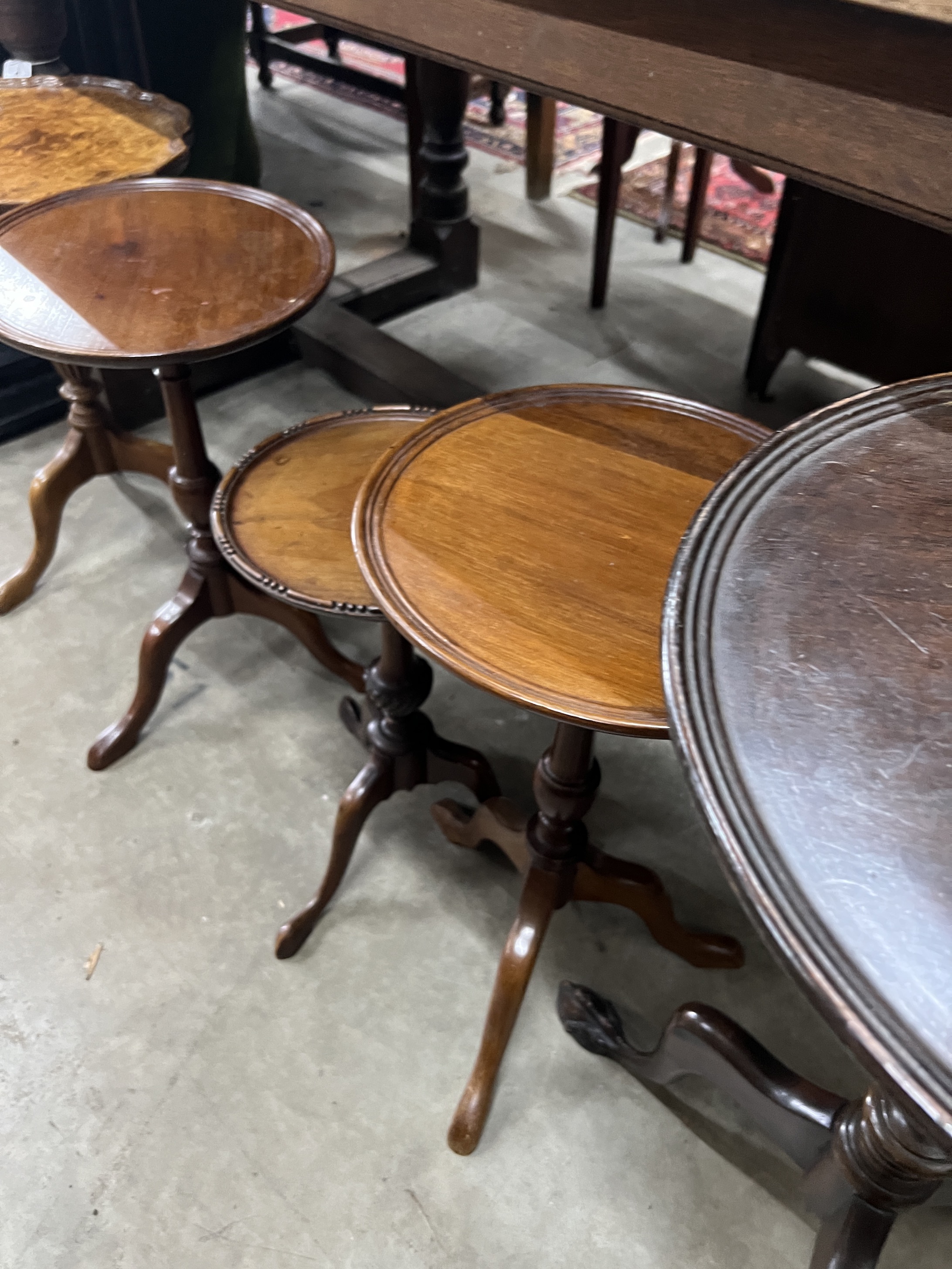 Five early 20th century and later circular mahogany and walnut tripod wine tables, largest diameter 37cm, height 63cm